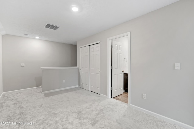 8806 Warbler Branch Way, Louisville, KY 40229 - unfurnished bedroom with visible vents, ensuite bathroom, a closet, baseboards, and light colored carpet