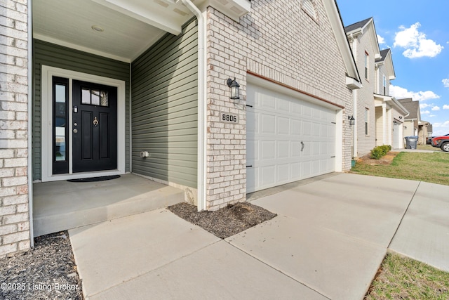 8806 Warbler Branch Way, Louisville, KY 40229 - property entrance featuring brick siding, a garage, and driveway