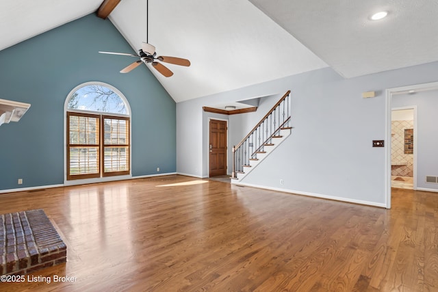 6709 Wild Fox Ln, Prospect, KY 40059 - unfurnished living room with high vaulted ceiling, wood finished floors, a ceiling fan, and stairway