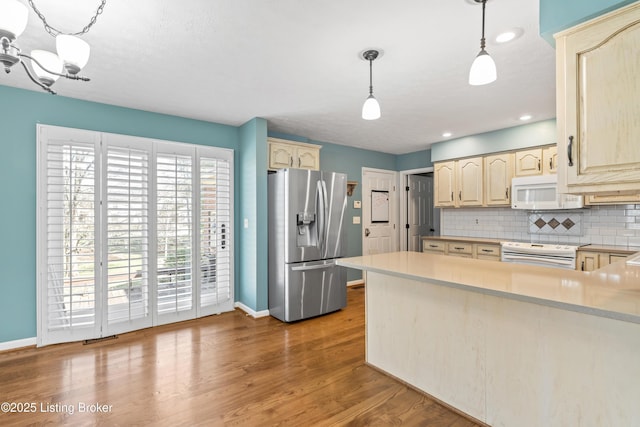 6709 Wild Fox Ln, Prospect, KY 40059 - kitchen with white appliances, tasteful backsplash, baseboards, a peninsula, and light countertops