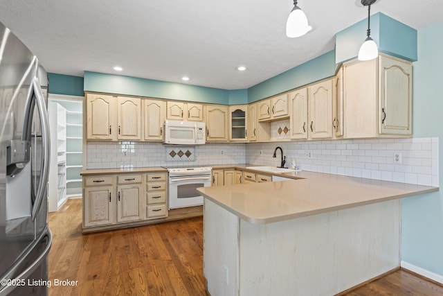 6709 Wild Fox Ln, Prospect, KY 40059 - kitchen featuring white appliances, backsplash, a sink, a peninsula, and dark wood-type flooring