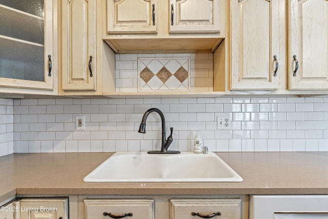 6709 Wild Fox Ln, Prospect, KY 40059 - kitchen featuring backsplash, glass insert cabinets, and a sink