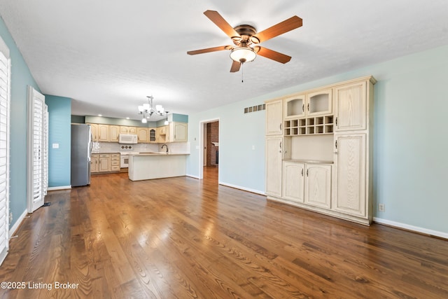 6709 Wild Fox Ln, Prospect, KY 40059 - unfurnished living room featuring dark wood-style floors, visible vents, baseboards, and ceiling fan with notable chandelier