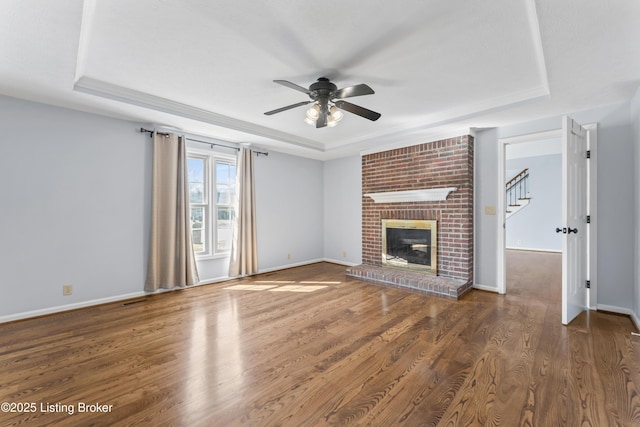 6709 Wild Fox Ln, Prospect, KY 40059 - unfurnished living room with wood finished floors, a raised ceiling, ceiling fan, and baseboards