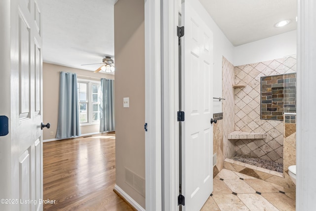 6709 Wild Fox Ln, Prospect, KY 40059 - bathroom with ceiling fan, toilet, a tile shower, visible vents, and wood finished floors
