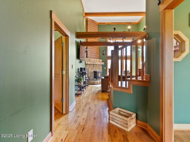 hallway featuring baseboards and wood finished floors