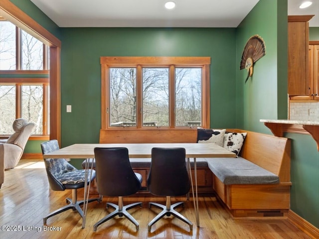 dining space featuring baseboards, recessed lighting, breakfast area, and light wood-style floors