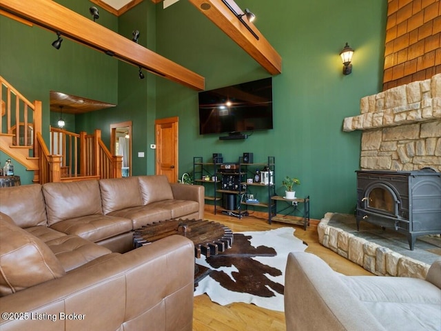 living room with a high ceiling, wood finished floors, and stairway
