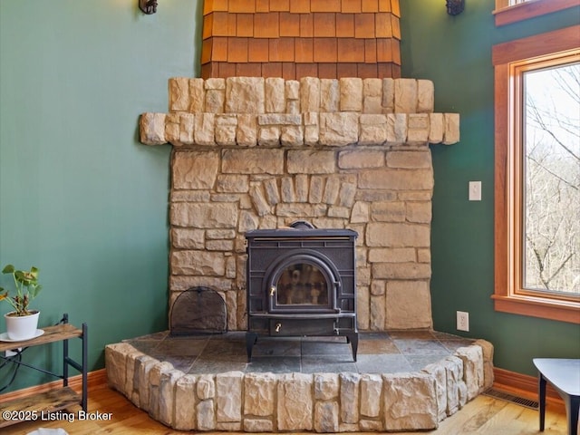 room details featuring wood finished floors, baseboards, and visible vents