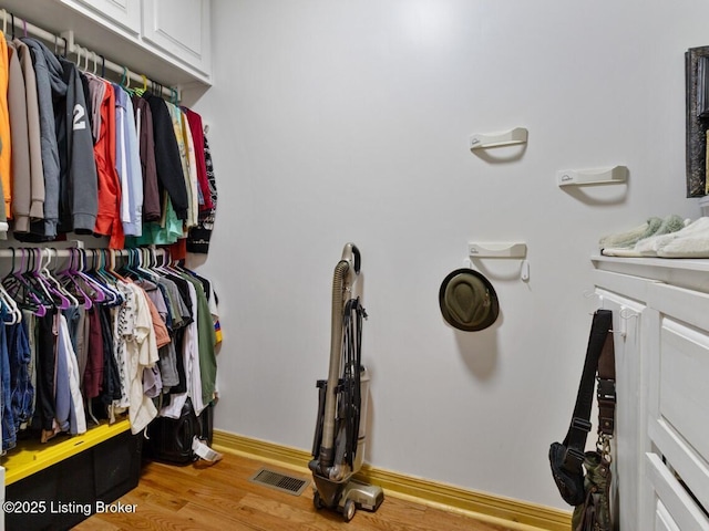 spacious closet featuring visible vents and wood finished floors