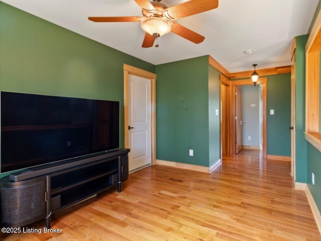 unfurnished living room with baseboards, ceiling fan, and light wood-type flooring