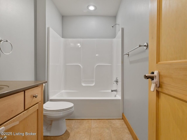 bathroom featuring toilet, vanity, tile patterned floors, and tub / shower combination