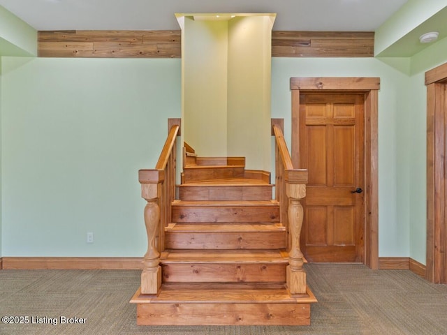 stairs with carpet and baseboards