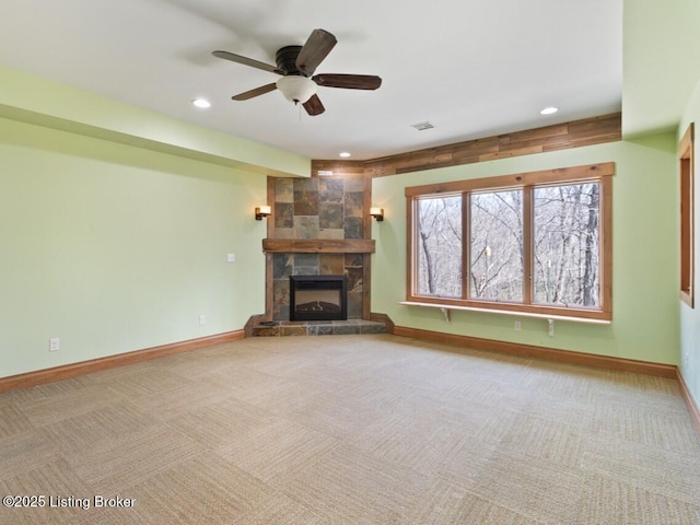 unfurnished living room with carpet flooring, baseboards, and ceiling fan