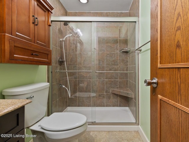 full bath with toilet, a stall shower, and vanity