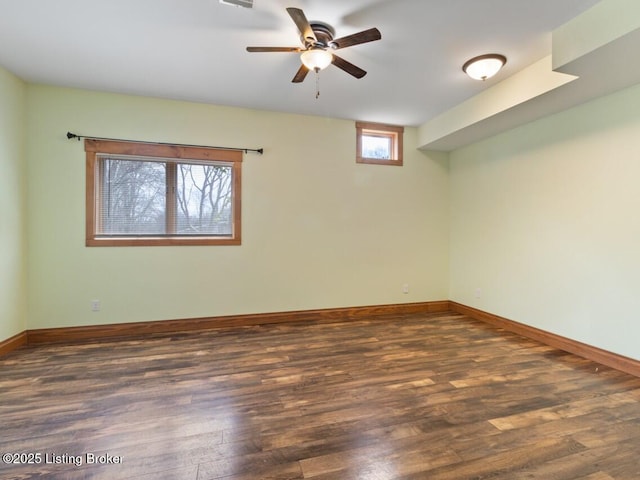 unfurnished room with baseboards, wood finished floors, and a ceiling fan