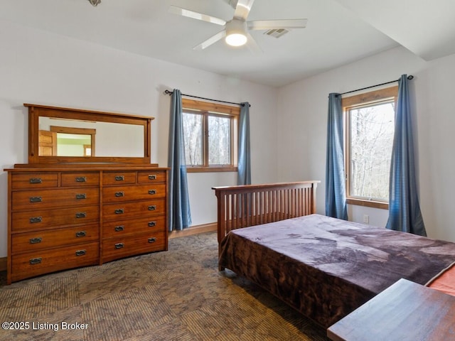 bedroom featuring visible vents, multiple windows, and a ceiling fan