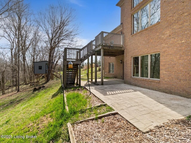 view of yard featuring stairs, a deck, and a patio area