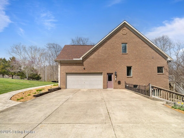 view of property exterior featuring brick siding, concrete driveway, and a lawn