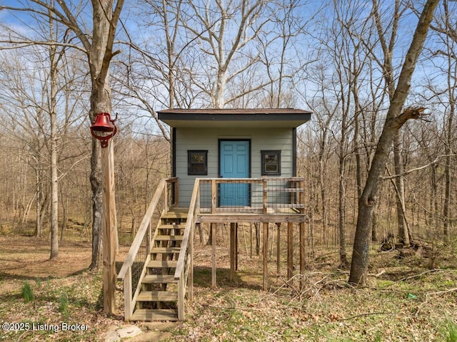 view of outbuilding featuring stairs
