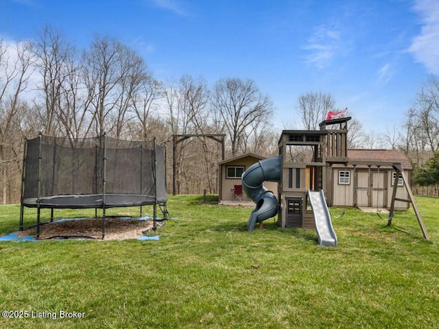 view of play area with a yard, an outdoor structure, and a trampoline