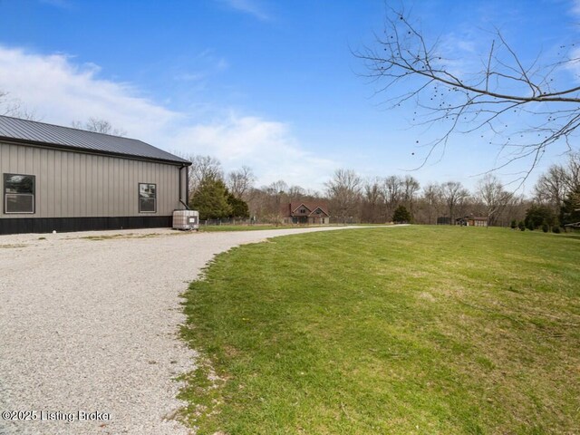 view of yard featuring curved driveway