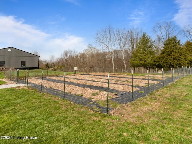view of yard featuring an outdoor structure, fence, a rural view, and a pole building