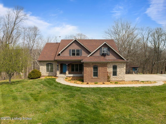craftsman-style house with stone siding, a porch, and a front yard