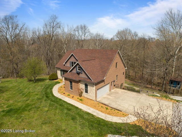 view of front of home featuring a front lawn, driveway, and stone siding