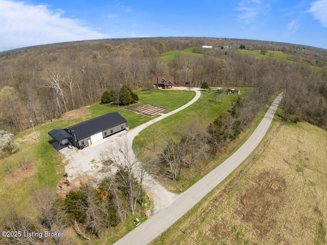 drone / aerial view featuring a forest view and a rural view