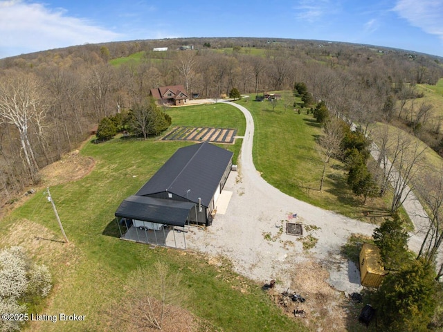 drone / aerial view featuring a view of trees