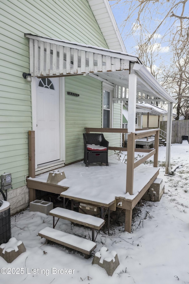 snow covered deck with fence