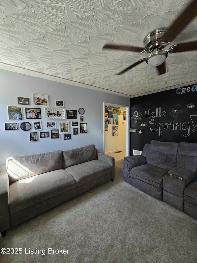 living area featuring ceiling fan and carpet flooring