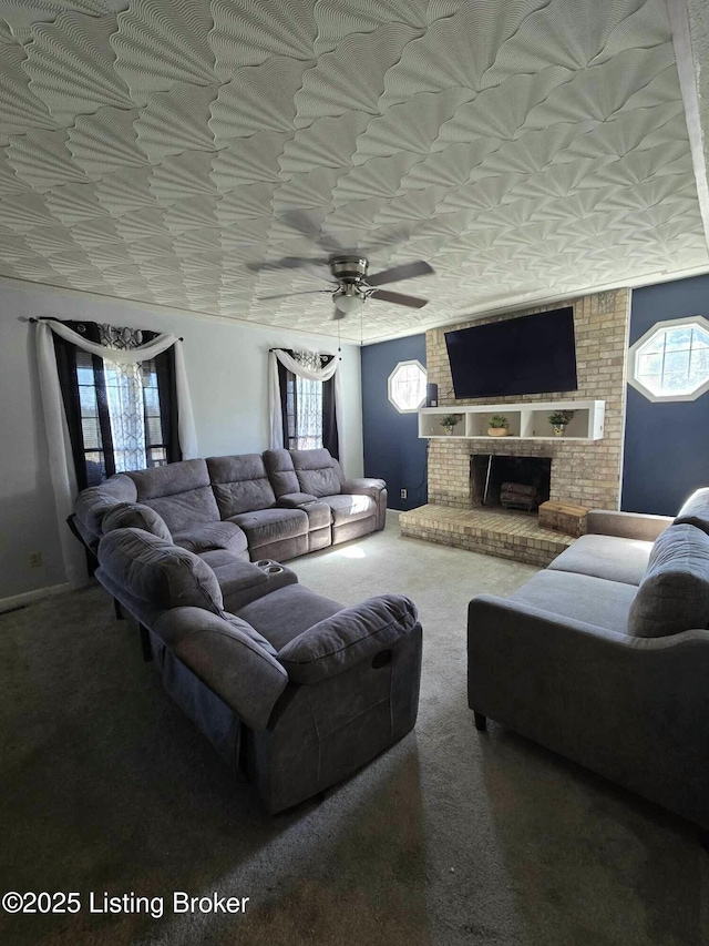 carpeted living room with plenty of natural light, a ceiling fan, and a fireplace