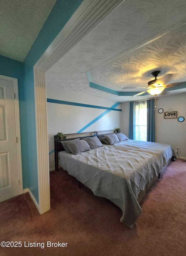 bedroom featuring baseboards, a textured ceiling, and carpet