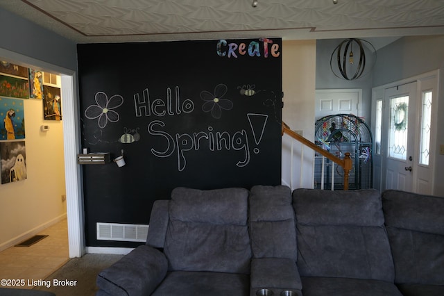 living area with visible vents and baseboards