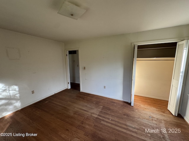 7725 3rd Street Rd, Louisville, KY 40214 - unfurnished bedroom featuring a closet, baseboards, and wood finished floors