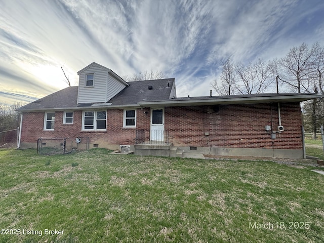 7725 3rd Street Rd, Louisville, KY 40214 - back of property featuring a lawn, brick siding, and fence