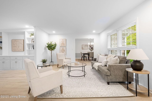1911 Bainbridge Row Dr, Louisville, KY 40207 - living area featuring recessed lighting, built in shelves, an inviting chandelier, and light wood-style flooring