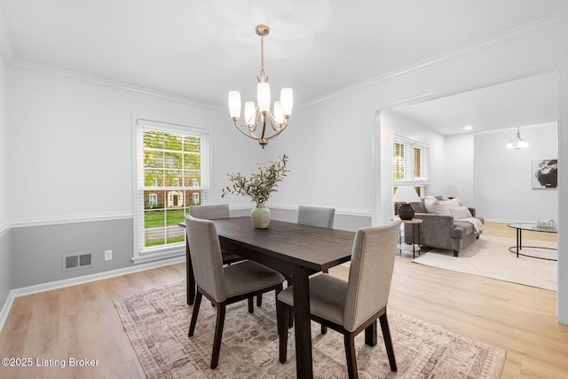 1911 Bainbridge Row Dr, Louisville, KY 40207 - dining area featuring a chandelier, light wood-type flooring, crown molding, visible vents, and baseboards