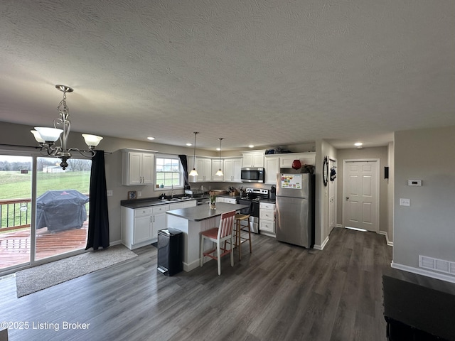 4177 Fairgrounds Rd, Brandenburg, KY 40108 - kitchen with a textured ceiling, visible vents, a sink, dark wood-style floors, and stainless steel appliances