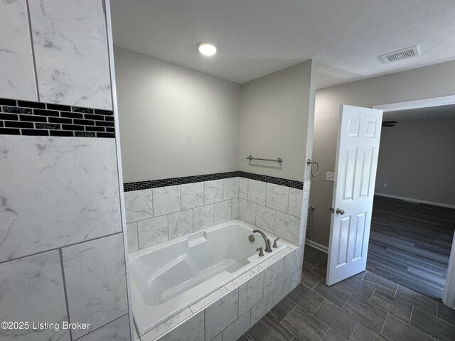 4177 Fairgrounds Rd, Brandenburg, KY 40108 - full bathroom with baseboards, tile patterned flooring, a bath, and visible vents