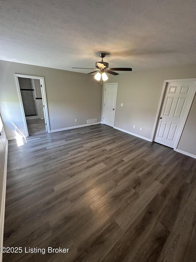 4177 Fairgrounds Rd, Brandenburg, KY 40108 - unfurnished bedroom with baseboards, dark wood-type flooring, a textured ceiling, and visible vents