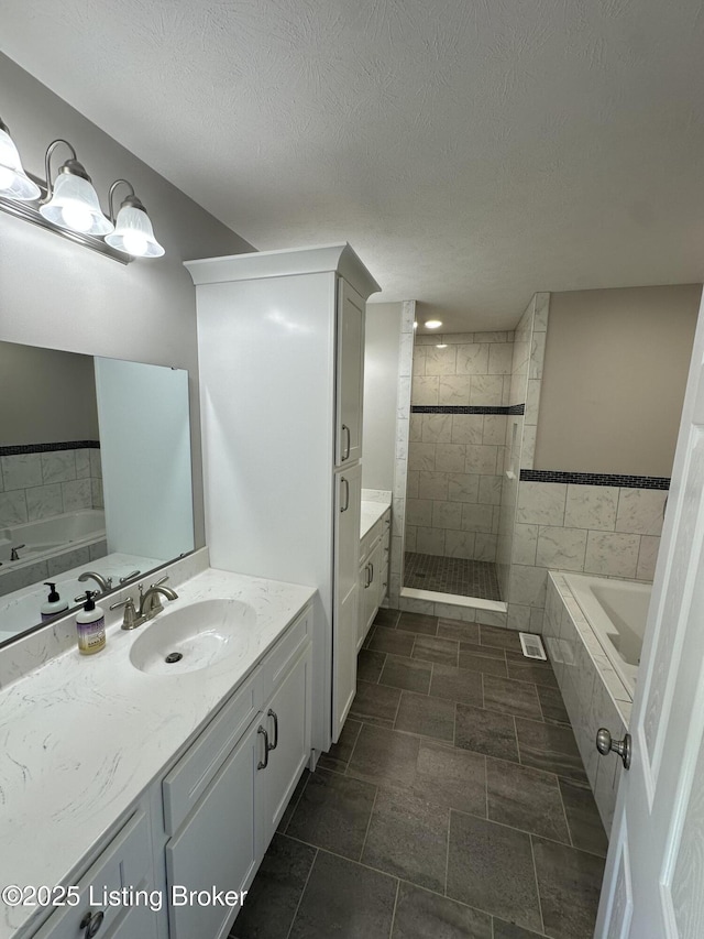 4177 Fairgrounds Rd, Brandenburg, KY 40108 - full bath with a textured ceiling, a tile shower, a garden tub, and vanity
