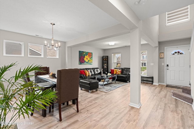 115 Shadow Rock Ct, Shepherdsville, KY 40165 - living room featuring visible vents, baseboards, a notable chandelier, and light wood finished floors