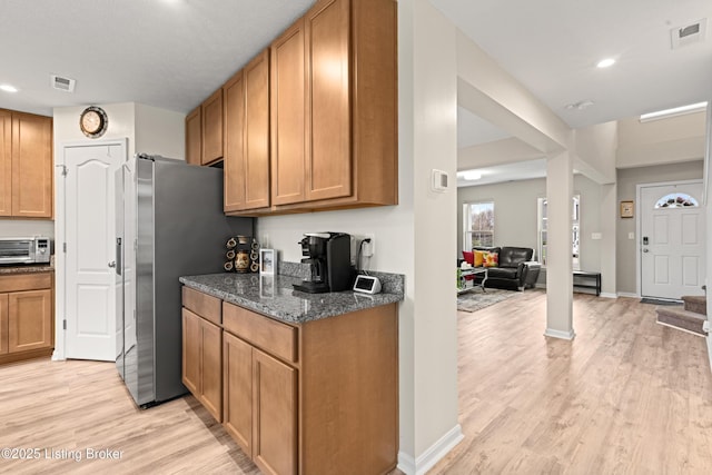 115 Shadow Rock Ct, Shepherdsville, KY 40165 - kitchen with dark stone counters, a toaster, light wood-style floors, and visible vents