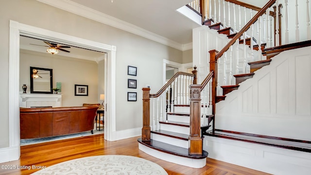 4742 Southern Pkwy, Louisville, KY 40214 - staircase featuring baseboards, a fireplace, ornamental molding, wood finished floors, and ceiling fan