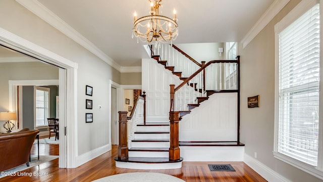 4742 Southern Pkwy, Louisville, KY 40214 - foyer featuring visible vents, a chandelier, crown molding, wood finished floors, and stairway