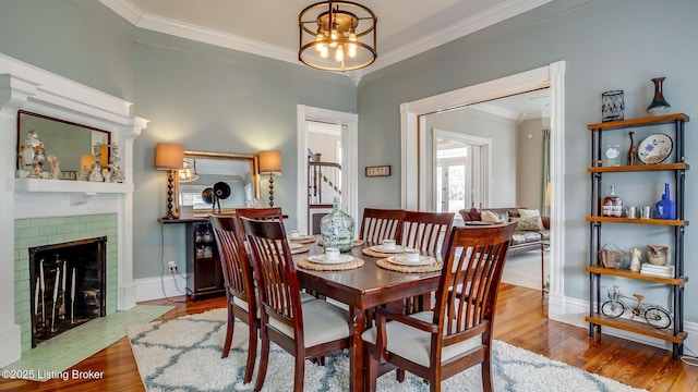 4742 Southern Pkwy, Louisville, KY 40214 - dining area with wood-type flooring, ornamental molding, and a notable chandelier
