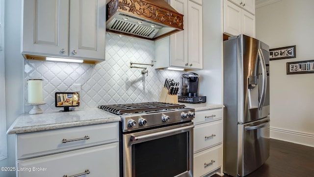 4742 Southern Pkwy, Louisville, KY 40214 - kitchen with white cabinetry, tasteful backsplash, custom exhaust hood, and appliances with stainless steel finishes
